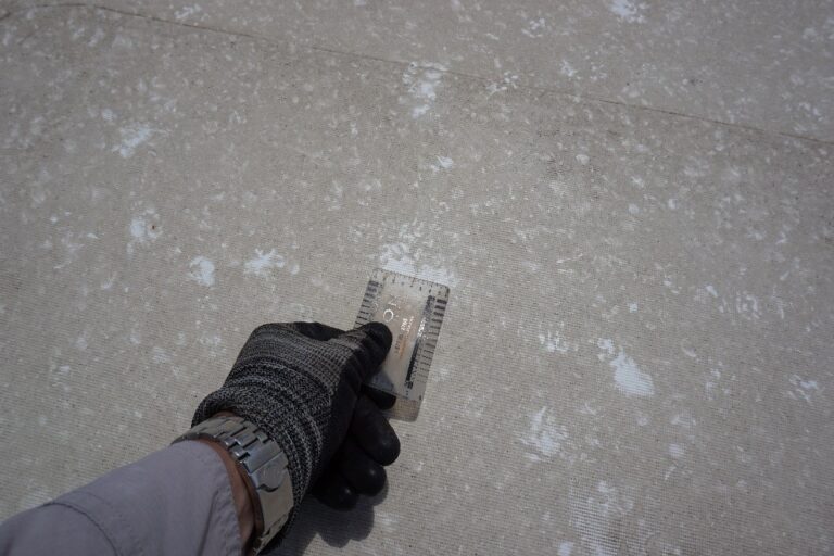Hail impact marks on a concrete walkway