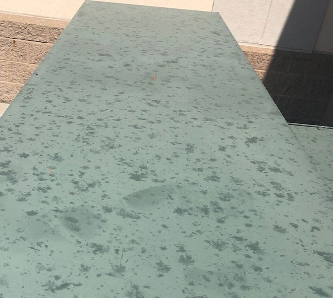 Hail impact marks on a soft metal roof edge